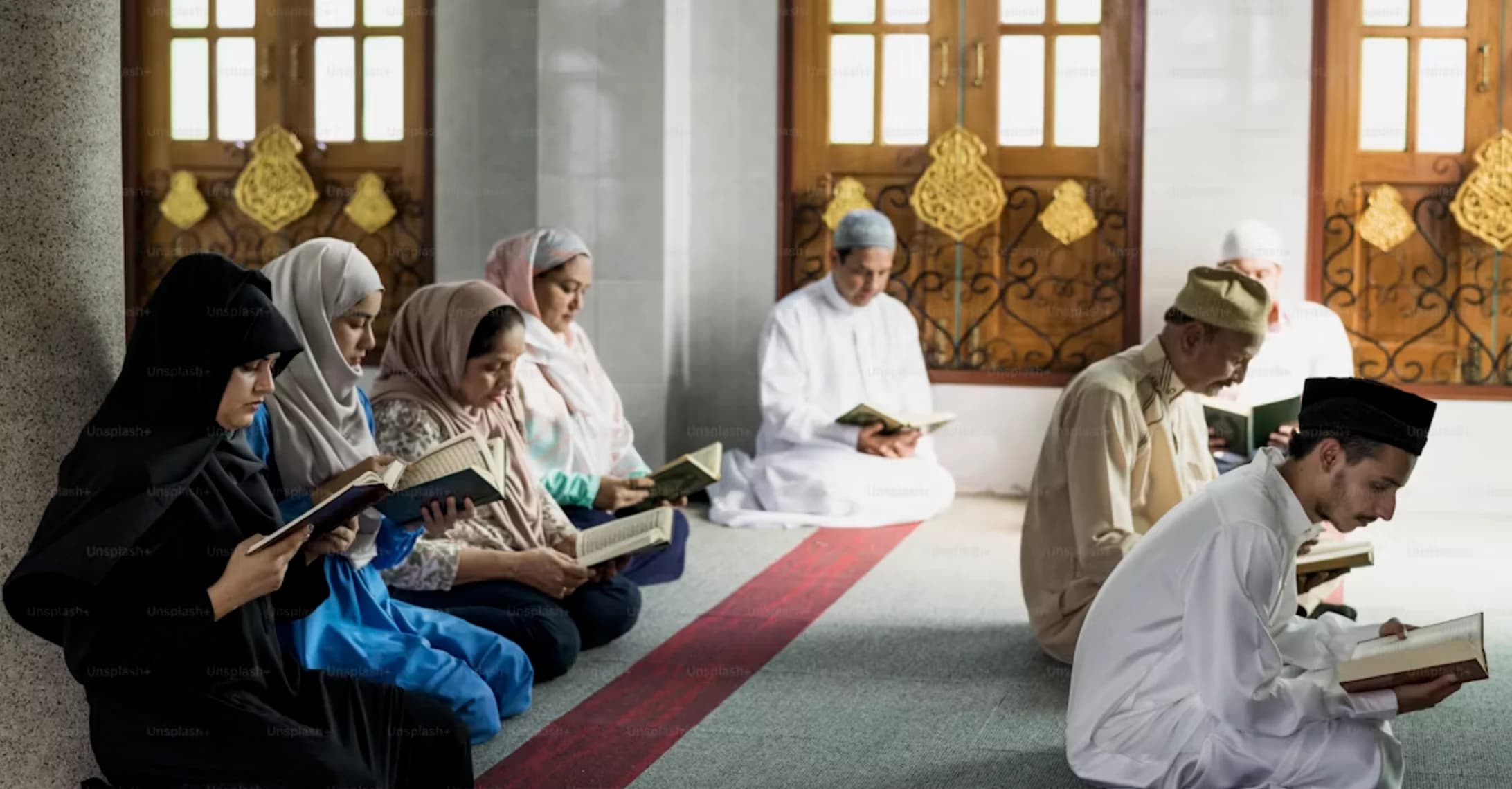 A diverse group reading the Qur’an together inside a mosque