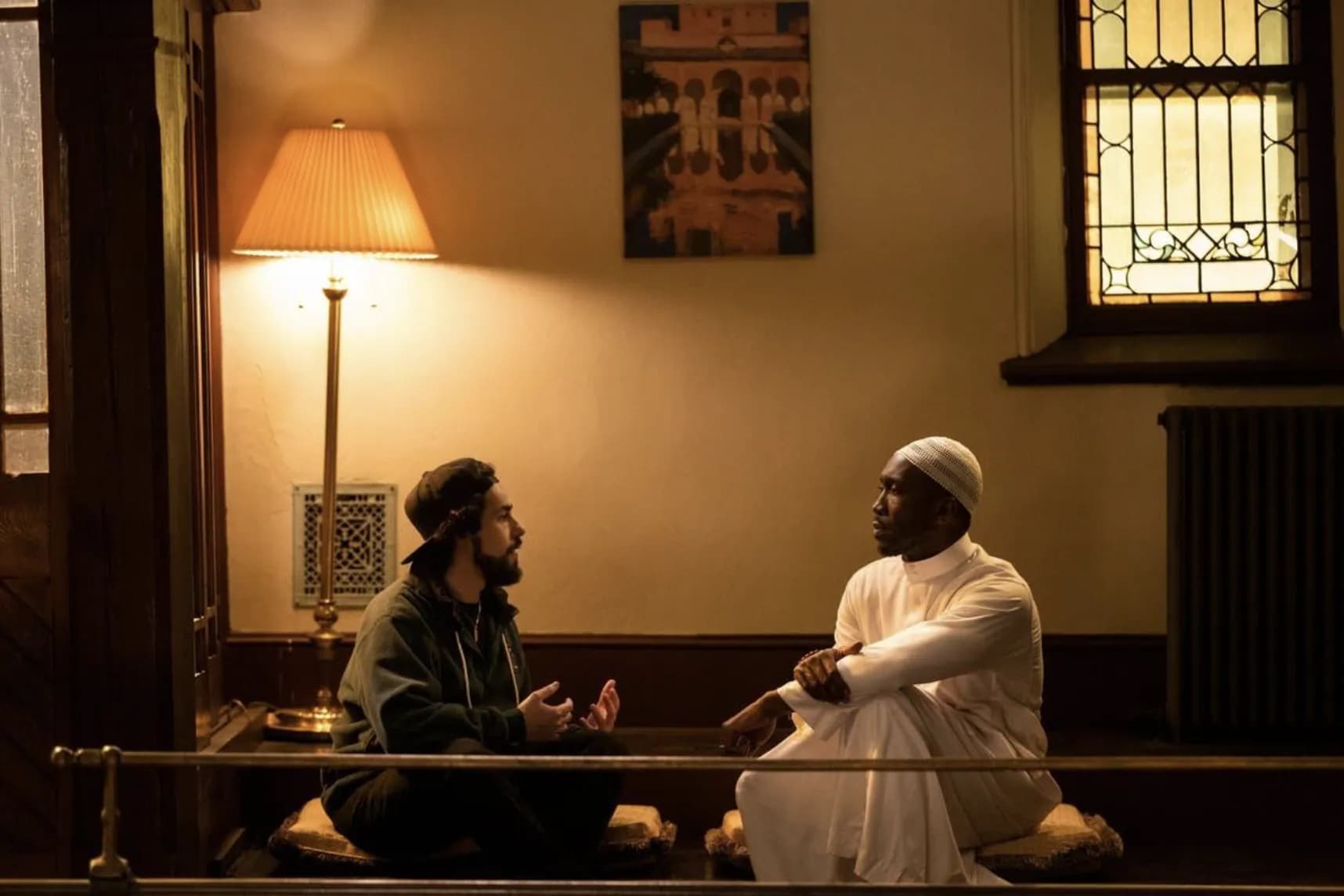 Two men having a thoughtful conversation in a quiet prayer space